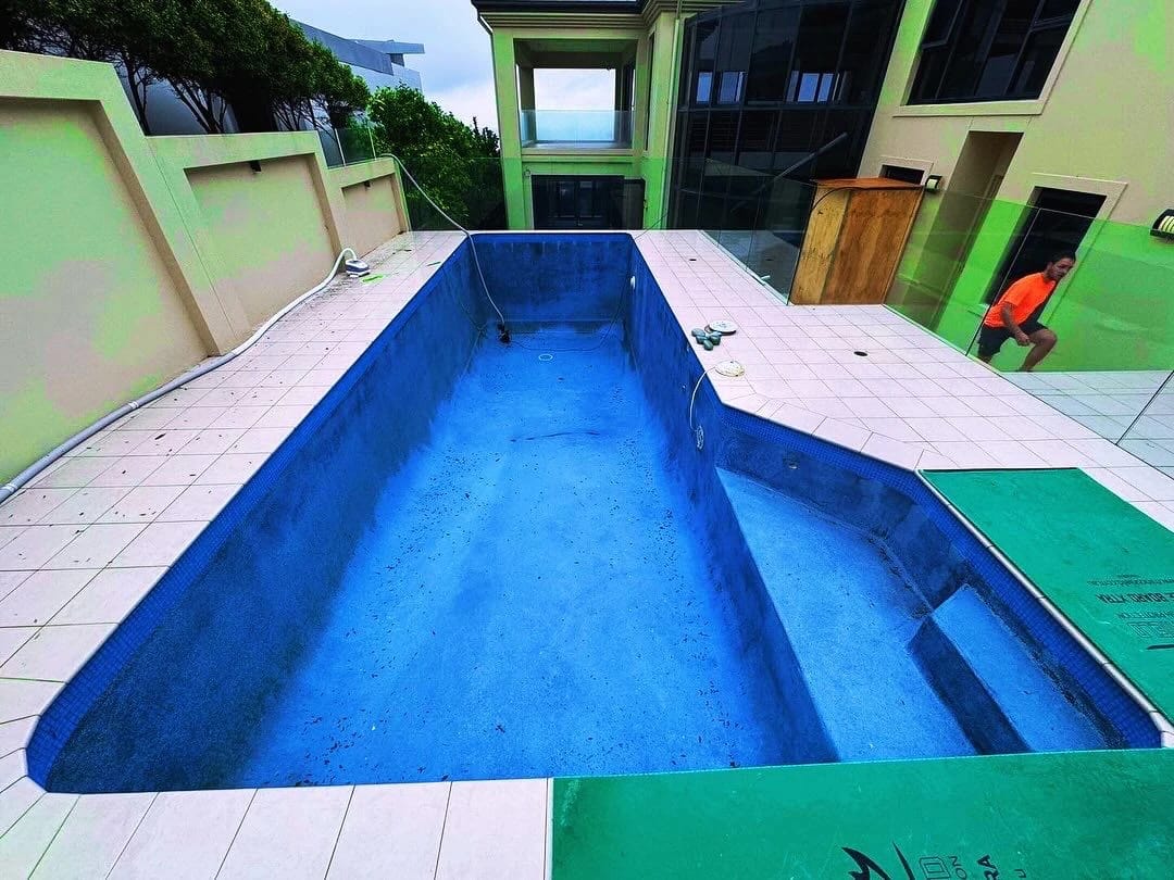 Blue-lined swimming pool before the interior surface was stripped