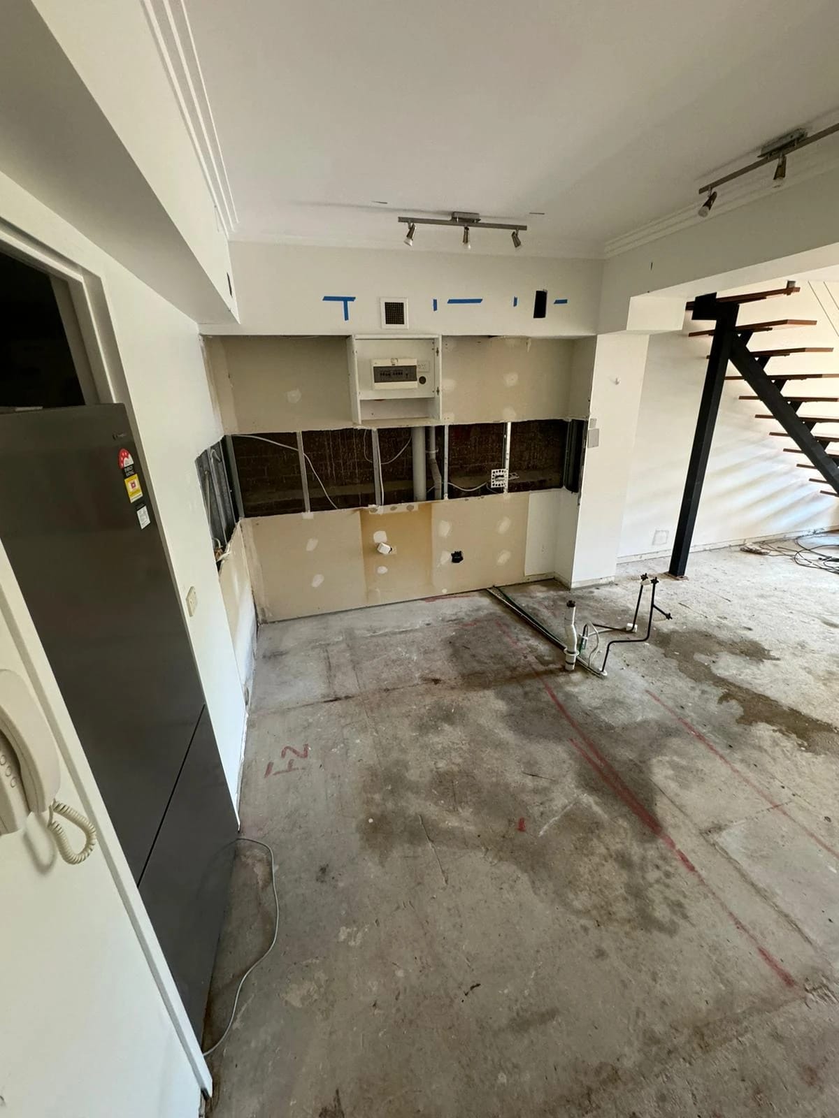 Same kitchen after cabinets, appliances and floor finishes were removed