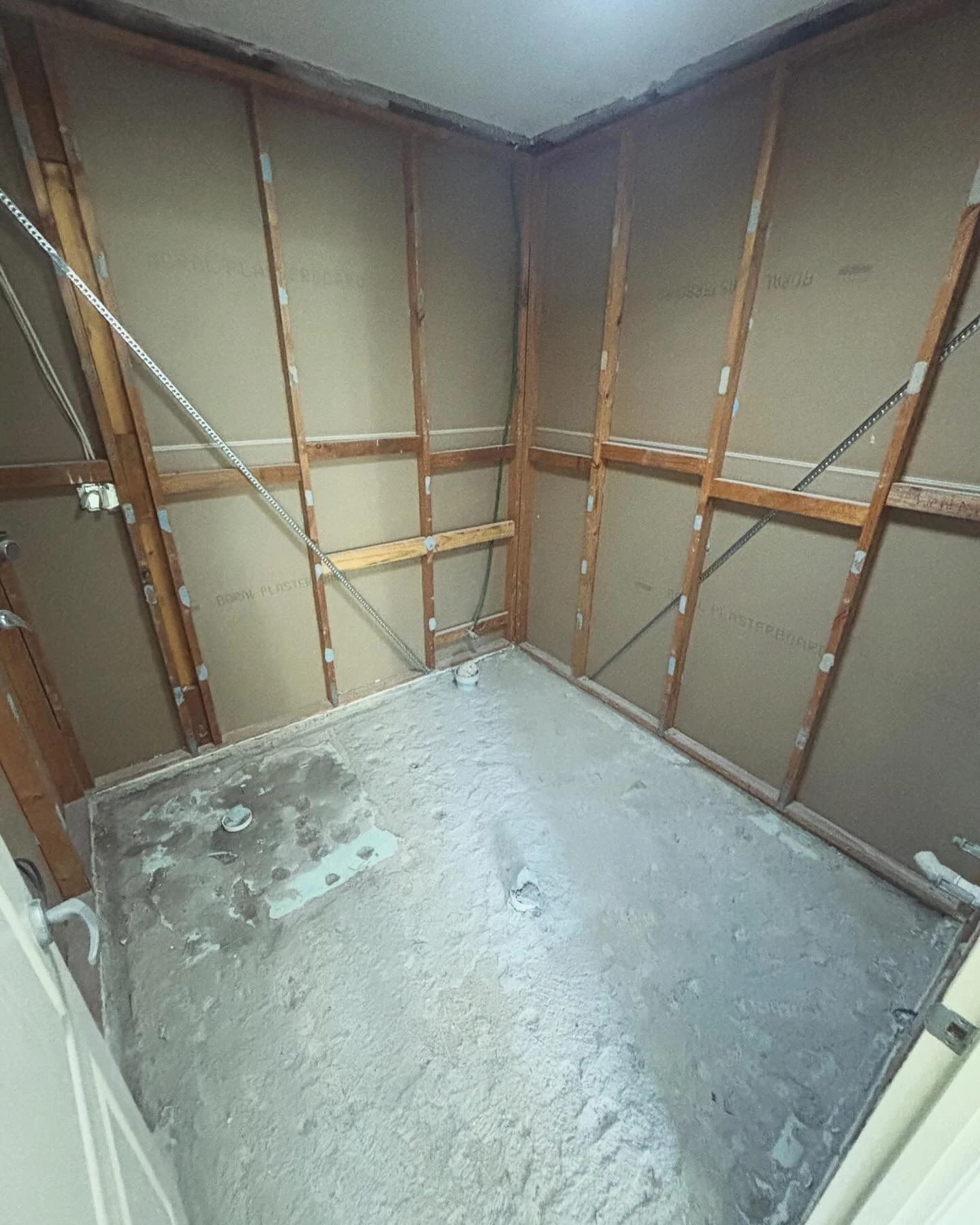 Same bathroom after fixtures and wall linings were removed