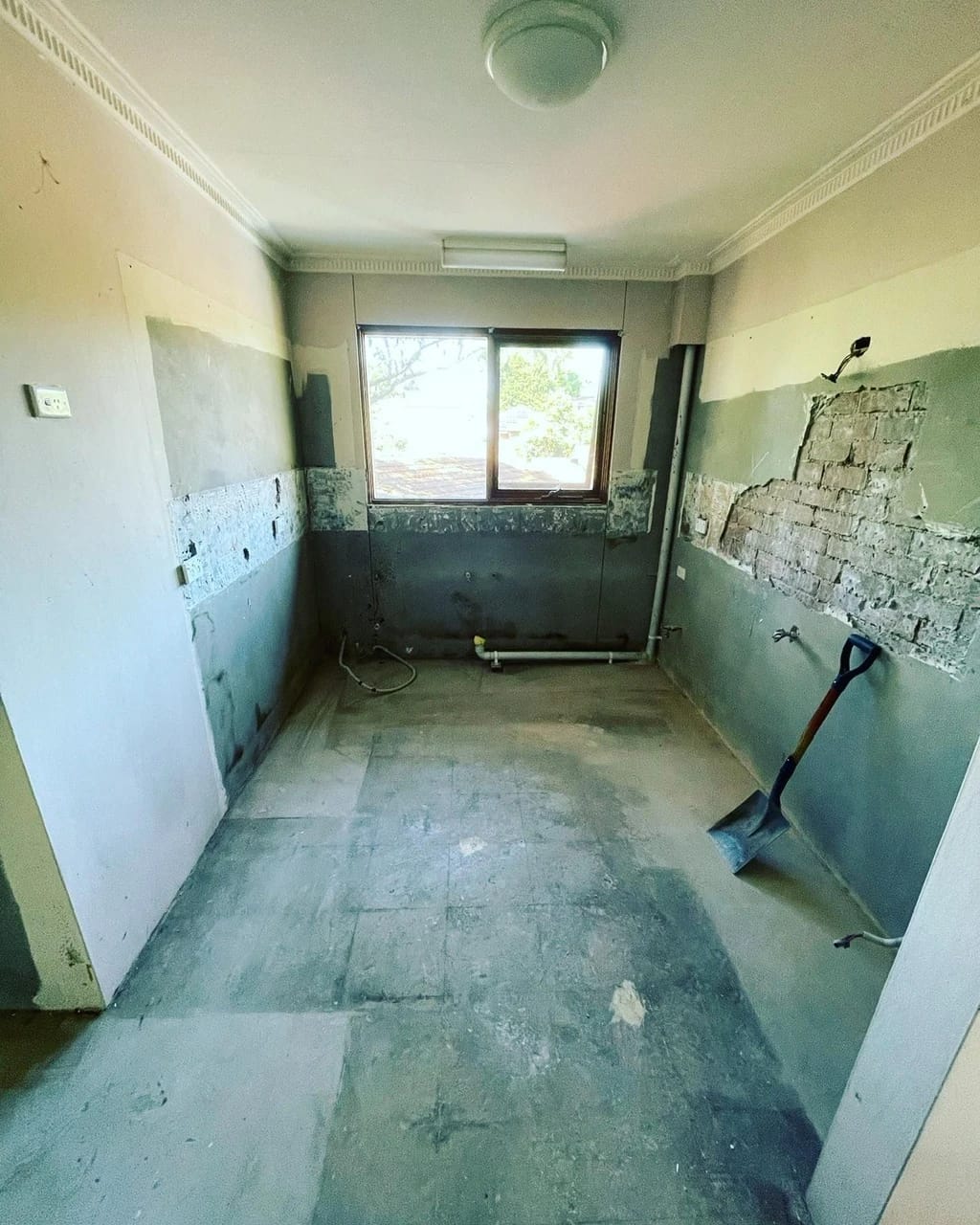 Same kitchen after cabinetry, appliances and floor finishes were removed