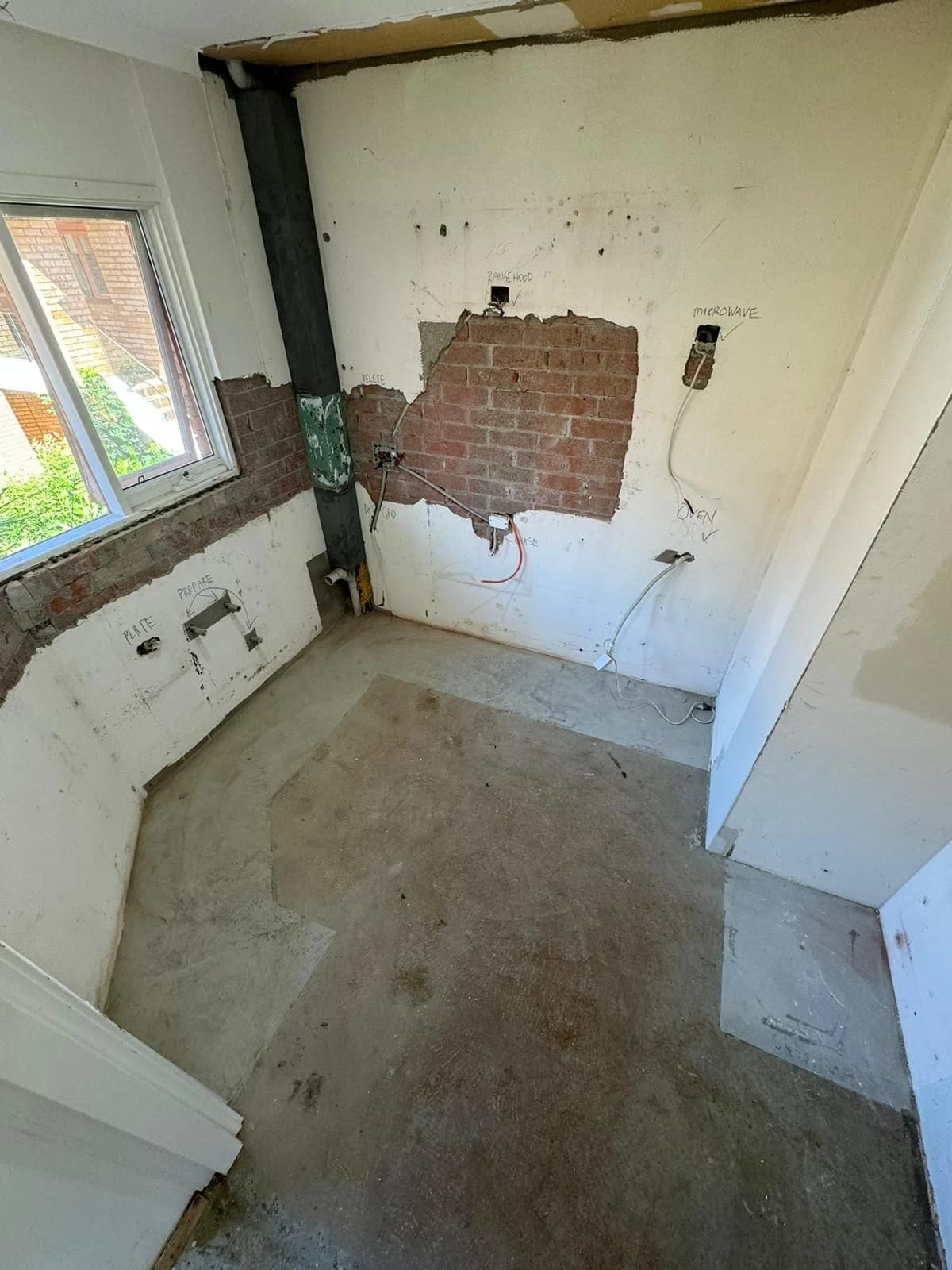 Same kitchen after cabinets, appliances and wall finishes were removed