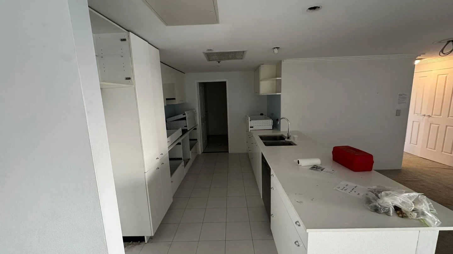 Apartment kitchen and adjoining living area before the internal strip out