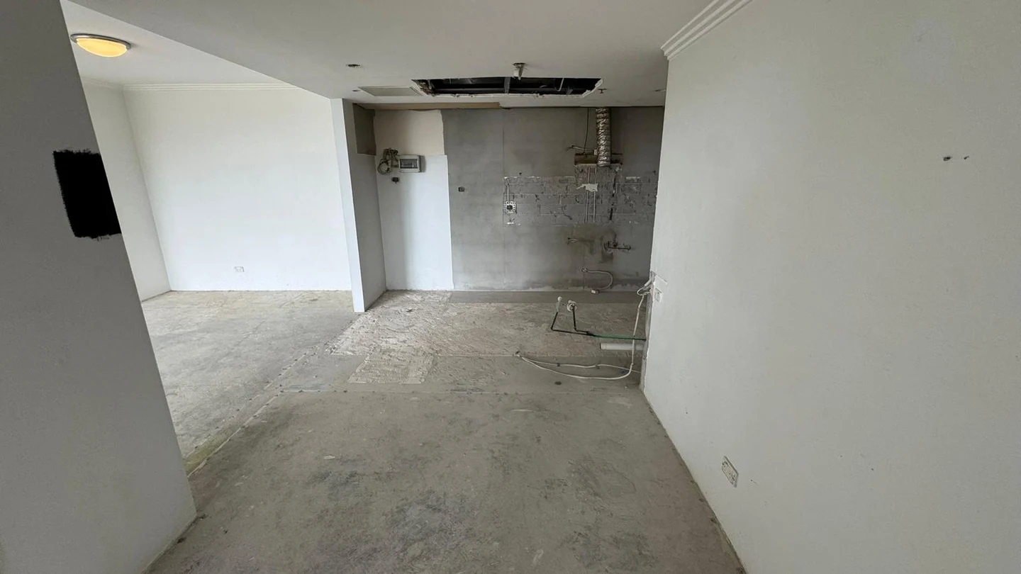 Apartment interior after the kitchen and floor finishes were removed