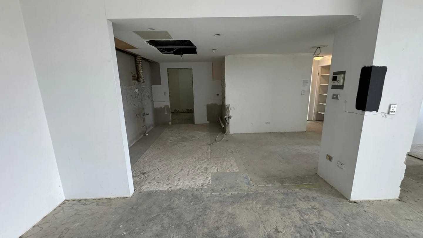 Open apartment living area after internal finishes and kitchen joinery were removed