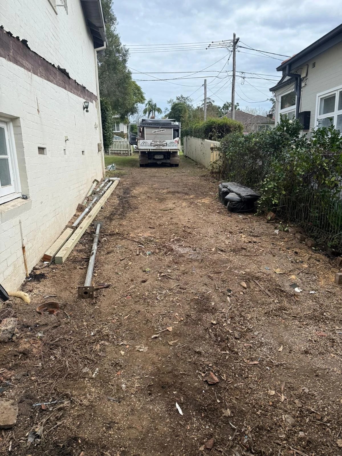 Cleared residential side access prepared for the builder to continue work