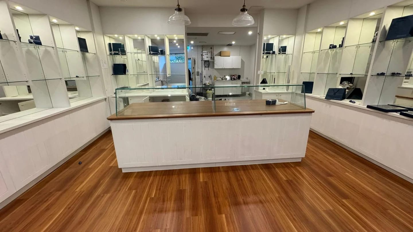 Chocolate shop before strip out with central counter and mirrored display cabinetry
