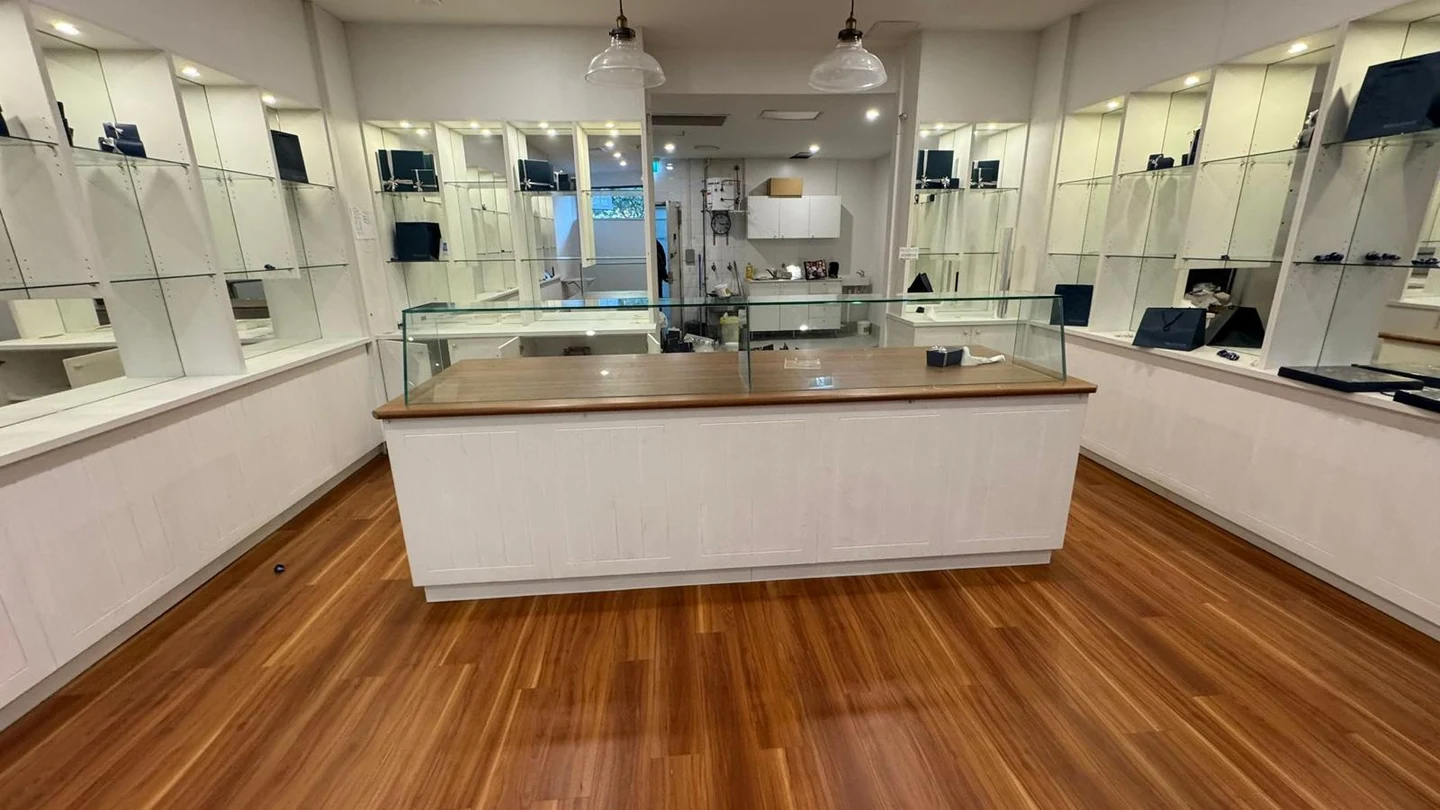 Chocolate shop before strip out with central counter and mirrored display cabinetry