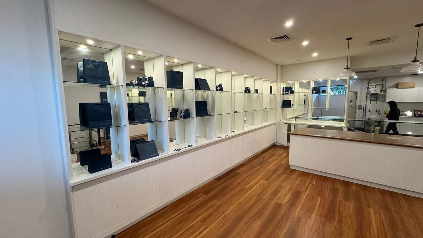 Chocolate shop before strip out with mirrored display joinery along the sales floor