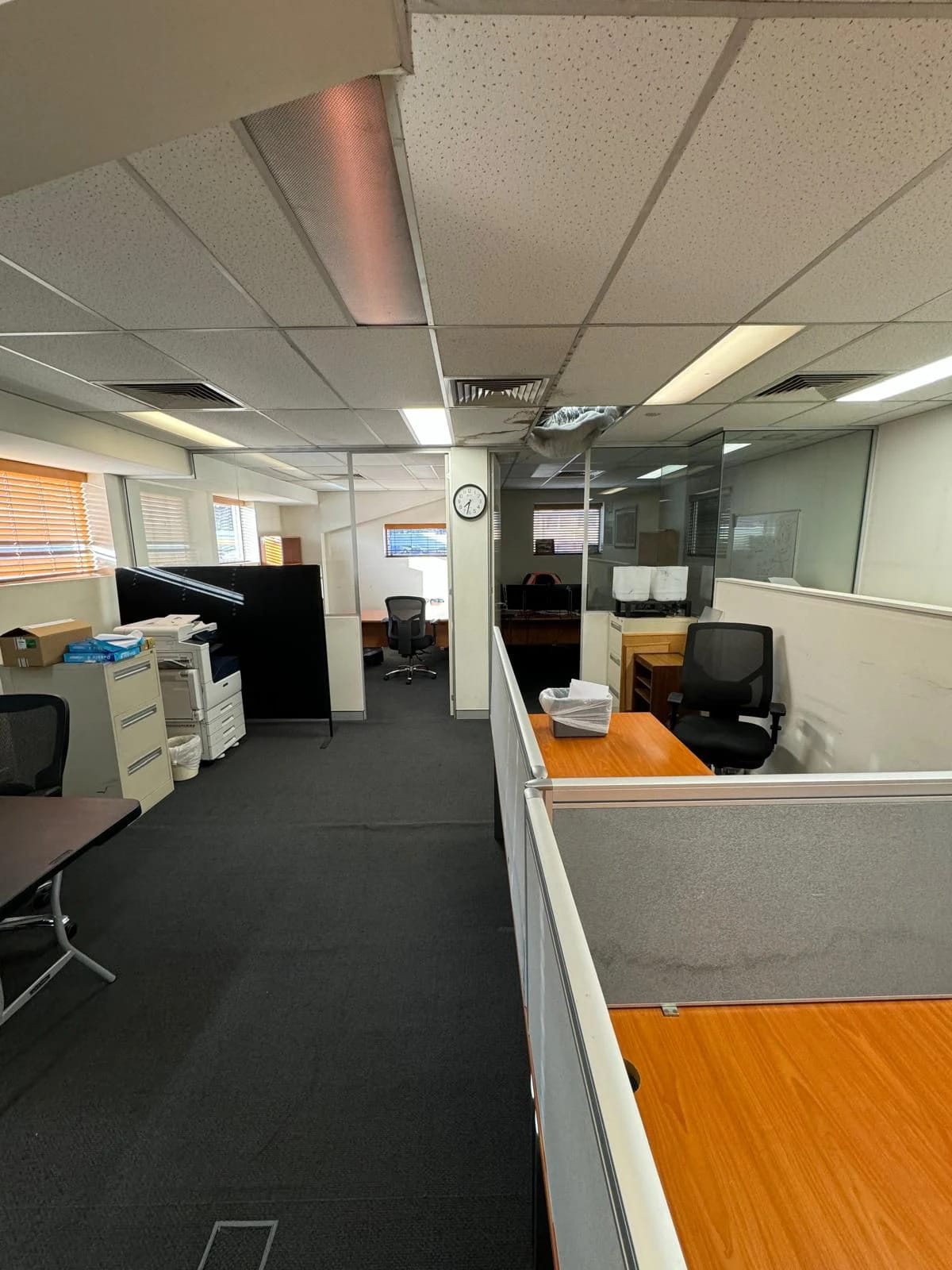 Commercial office before defit with cubicles, furniture and carpet in place