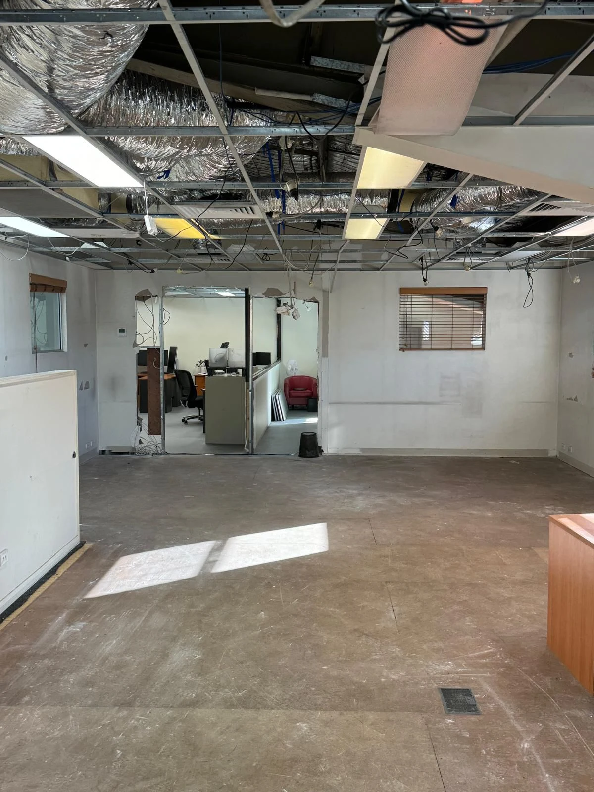 Open commercial work area after partitions and ceiling sections were removed