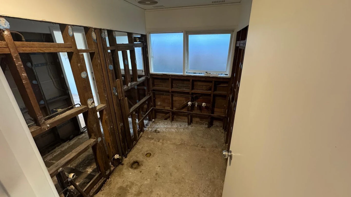 Bathroom stripped to timber framing and concrete substrate