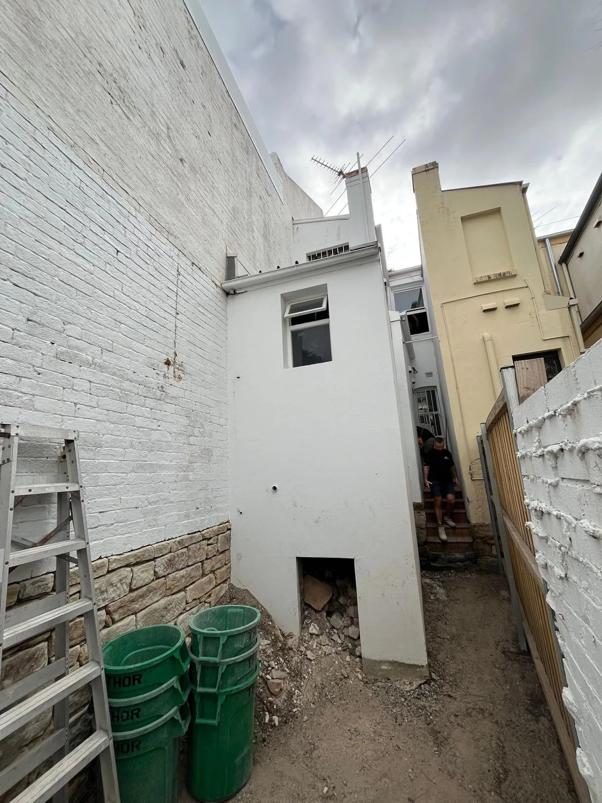 Narrow rear work area after selected structures and ground finishes were removed