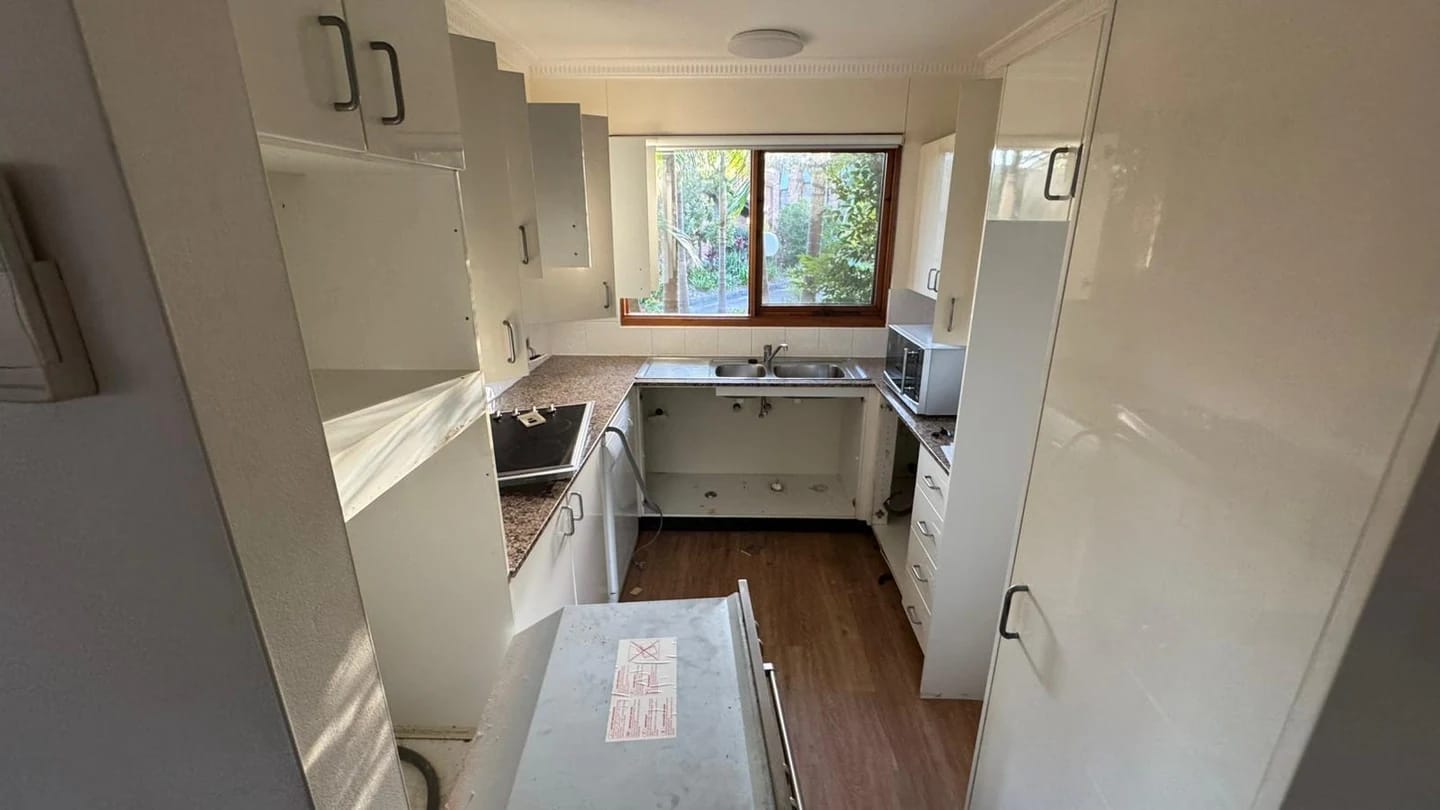 Residential corner kitchen before cabinetry, appliance and finish removal