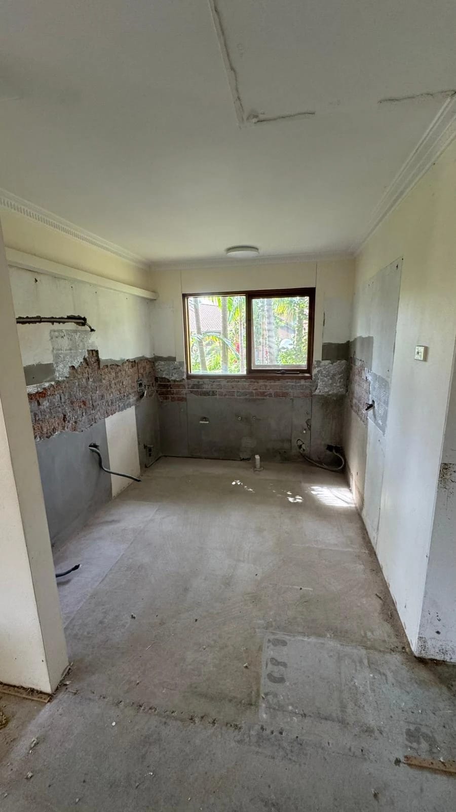 Residential kitchen after cabinetry, appliances and wall finishes were removed