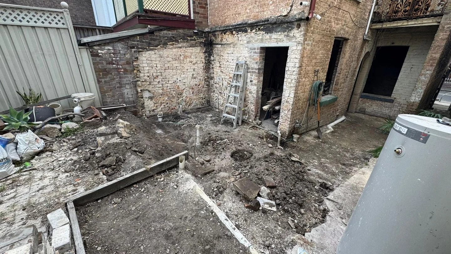 Residential masonry courtyard after selected outbuilding and ground removal