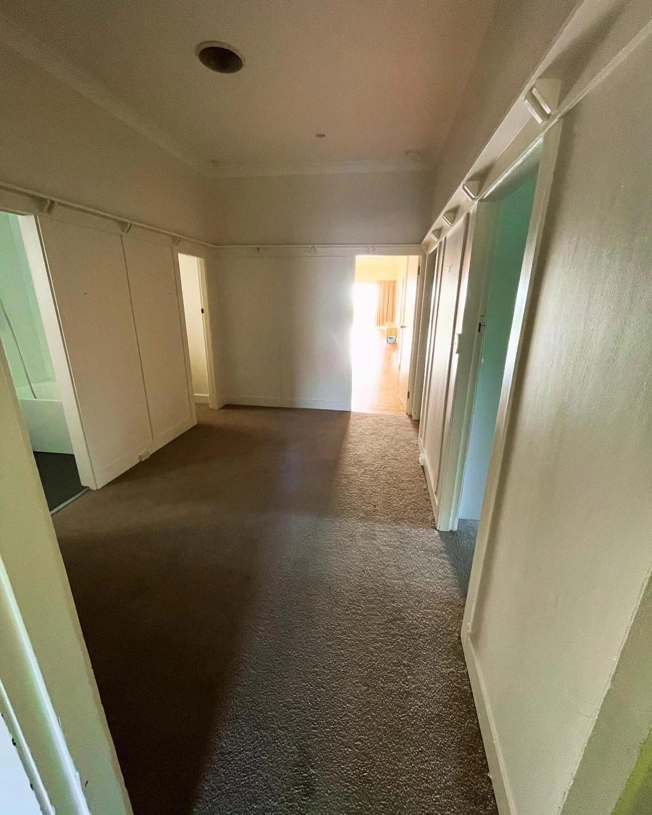 Finished residential hallway and adjoining rooms before strip out