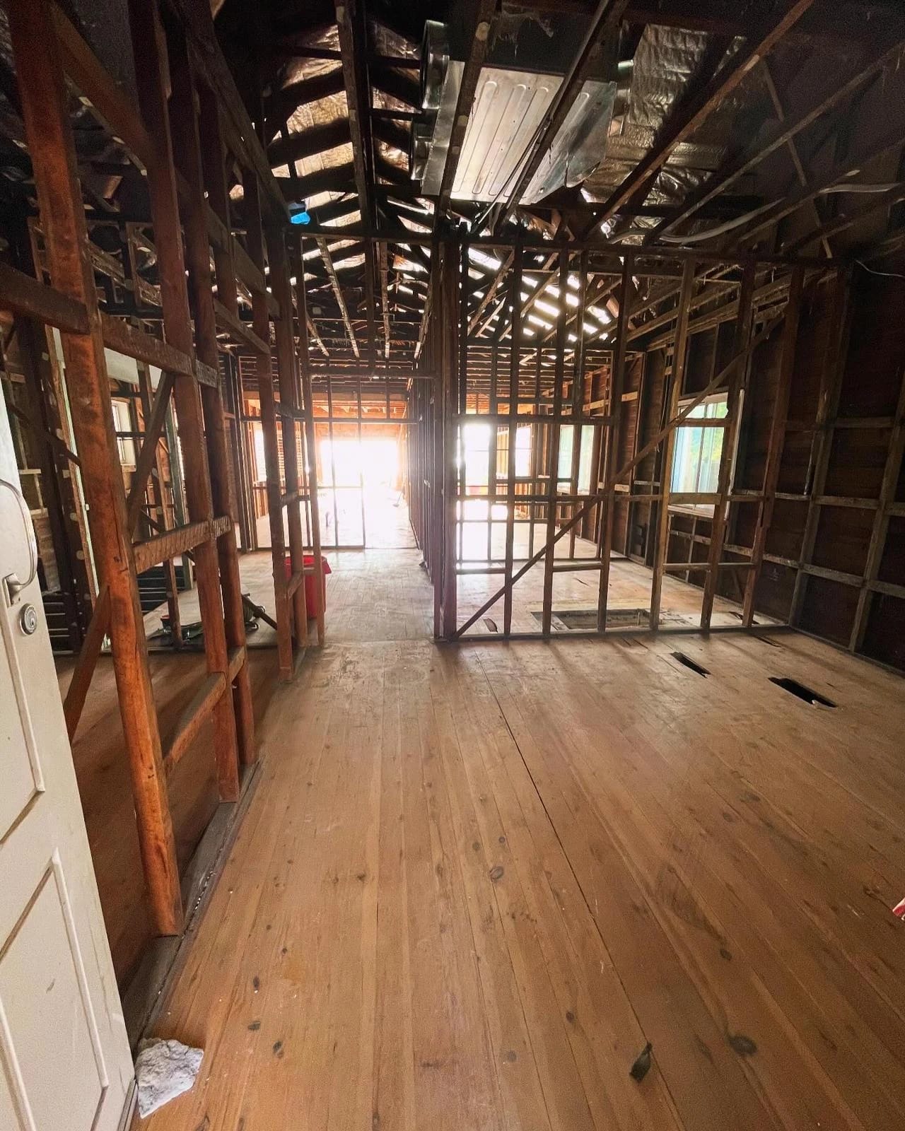 Residential room after wall linings were removed to expose the timber frame