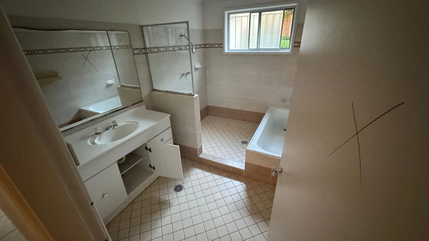 Bathroom before fixtures and finishes were removed