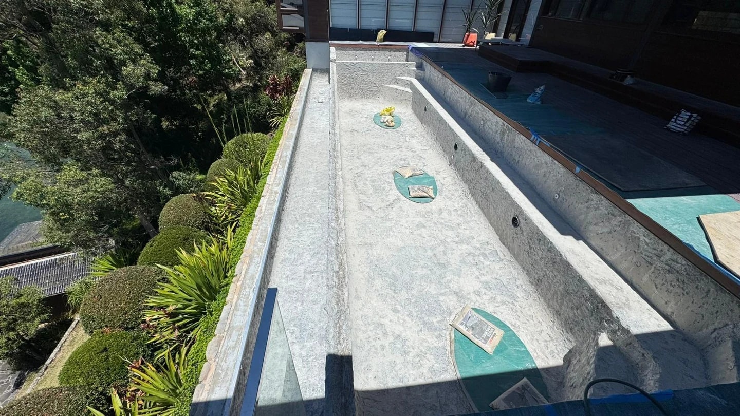 Elevated residential lap pool after green mosaic finishes were stripped away