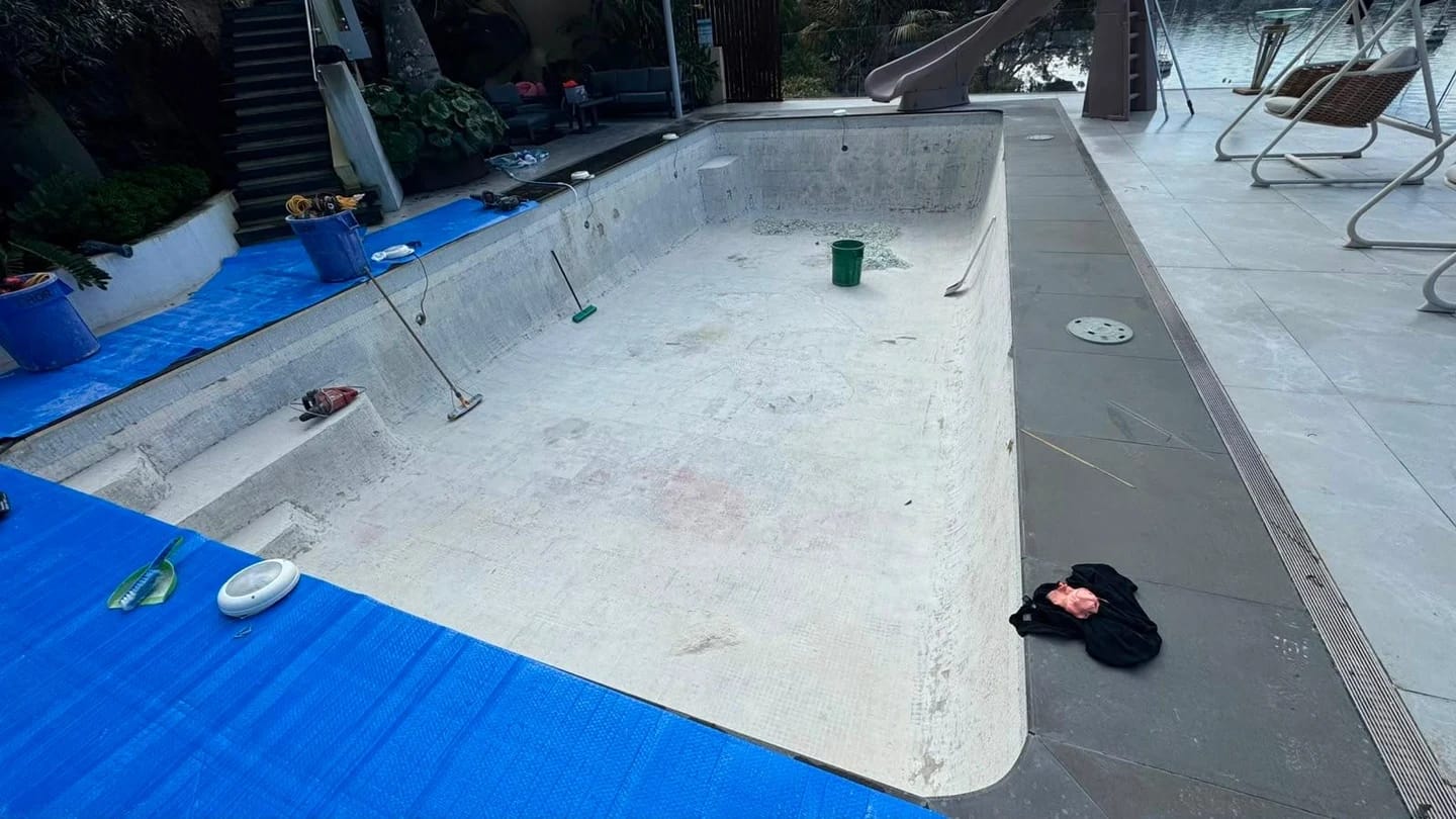 Same residential pool after the pale mosaic finish was stripped from the floor, walls and steps