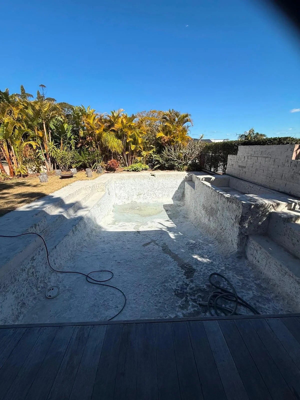 Residential pool and raised spa after the blue interior finish was stripped away