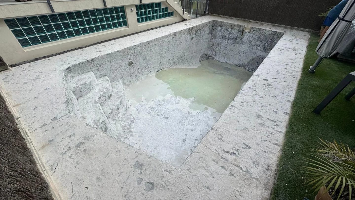 Pool shell and spa after the interior surface was stripped back