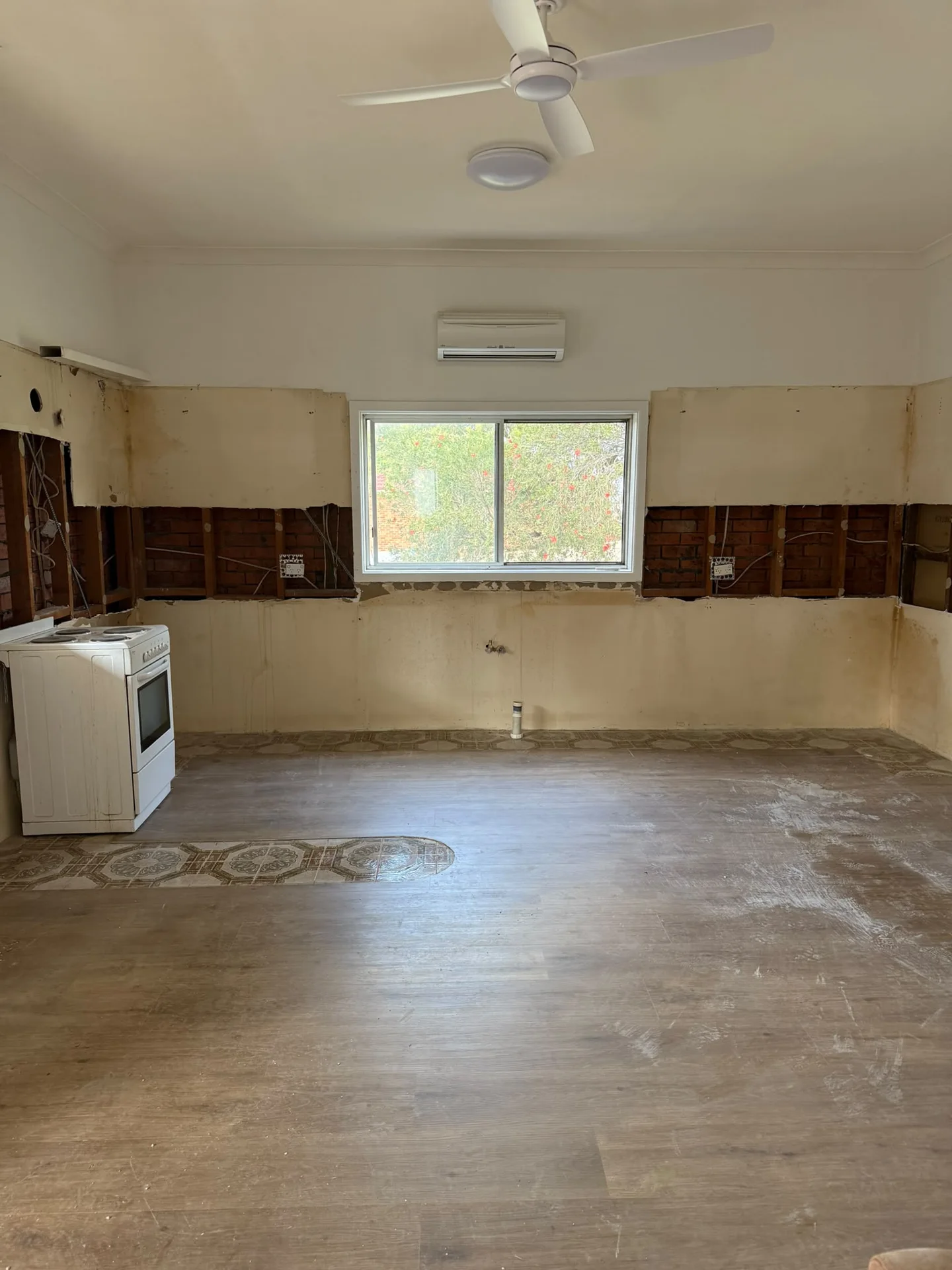 Ryde kitchen after cabinetry, benchtops and splashback removal, with the freestanding cooker retained