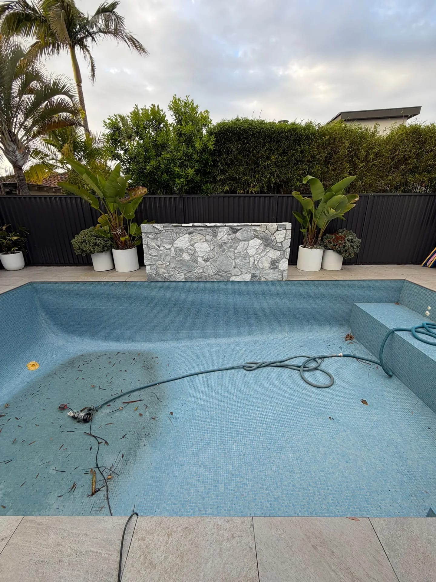 Blue mosaic pool interior and stone water feature before the Sylvania Waters strip out